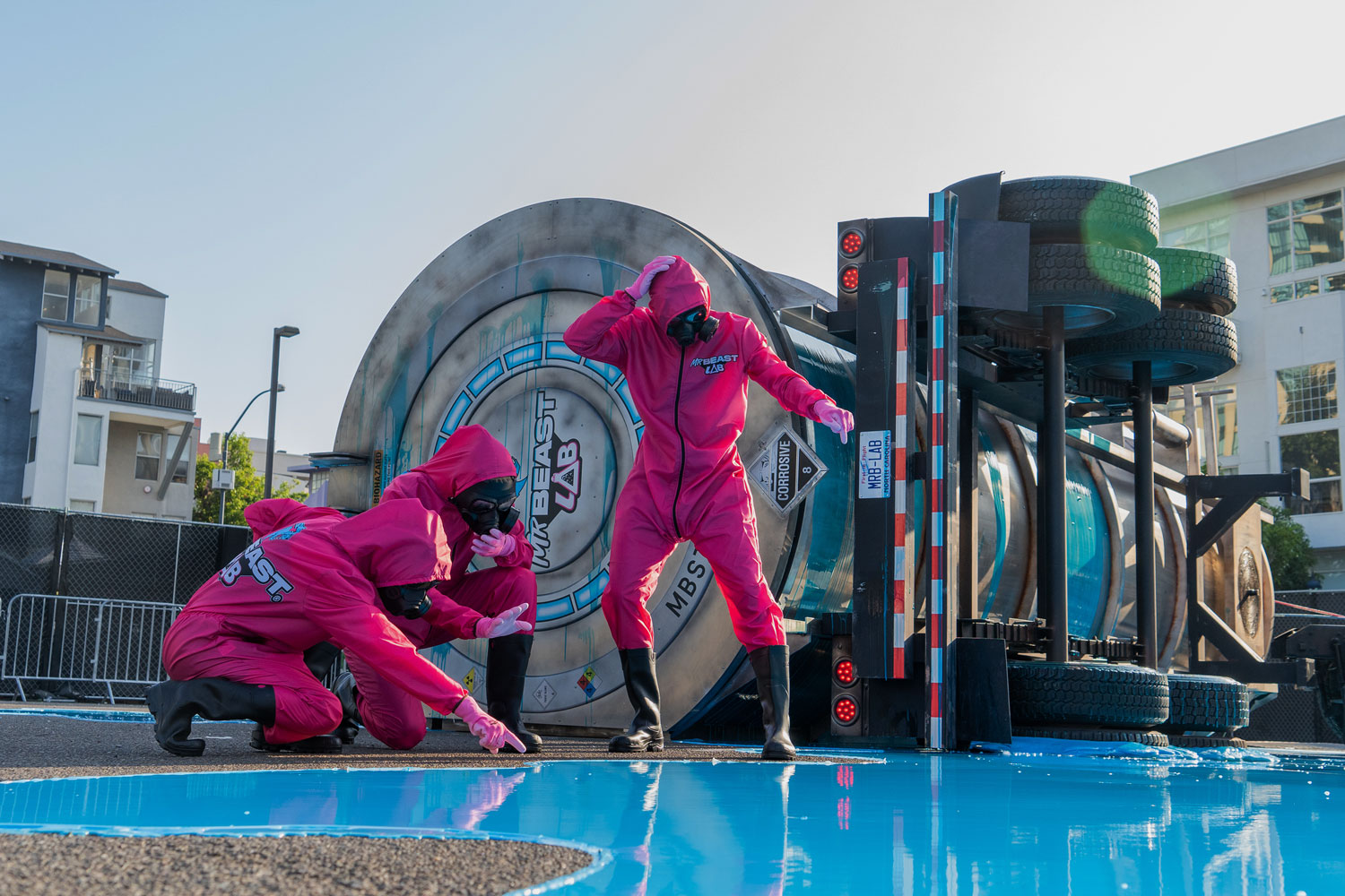 actors in hazmat suits at the mr. beast event in comic con