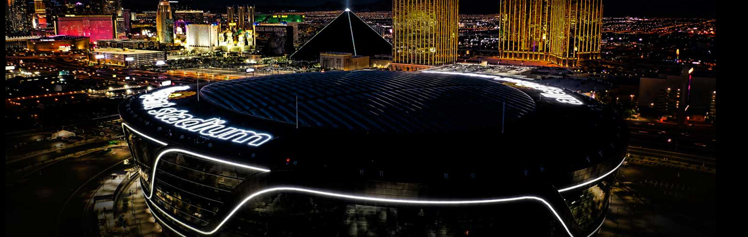 aerial image of allegiant stadium with the las vegas strip in background